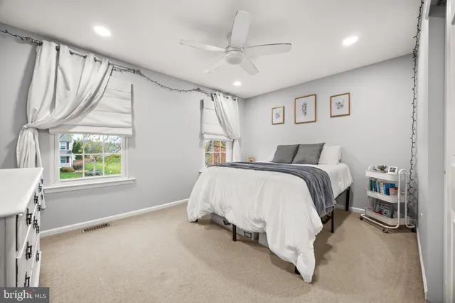 a bathroom with a granite countertop sink a toilet and a mirror