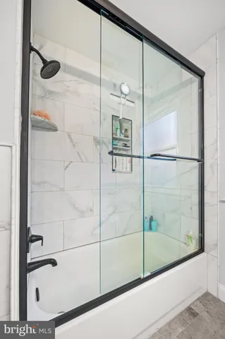 a bathroom with a granite countertop toilet a sink and a mirror