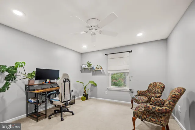 a bathroom with a granite countertop sink a toilet and a mirror