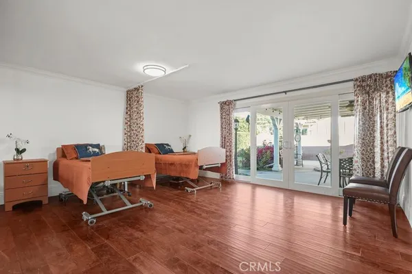a living room with furniture a table and wooden floor