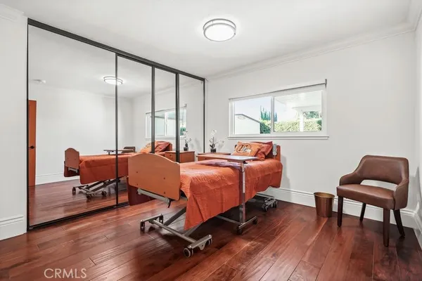 a bed room with furniture and wooden floor