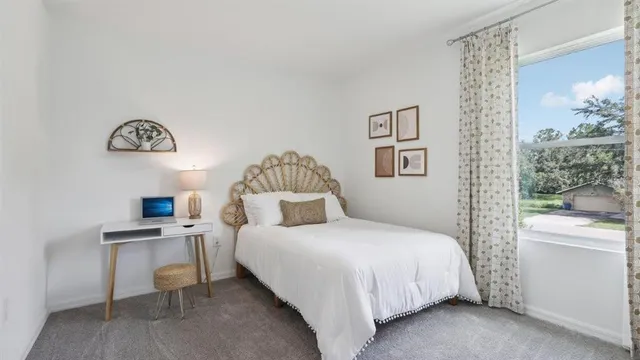 a bedroom with a bed and a table