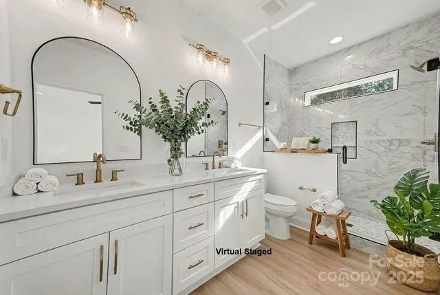 a bedroom with a large bed and a potted plant