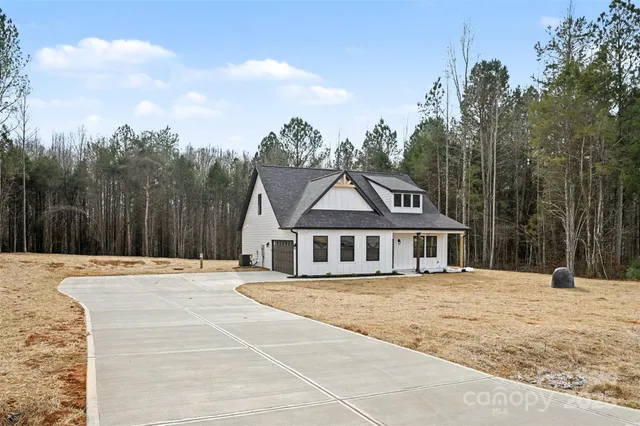 a view of a house with trees in the background
