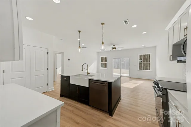 a view of a kitchen with a sink and a stove top oven