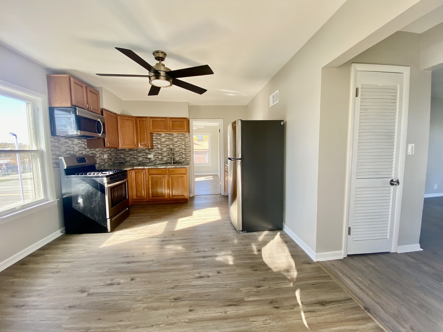 5543 West Margaret Street, Unit B Monee, IL 60449 - Photo 5 of 11 a kitchen with stainless steel appliances granite countertop a refrigerator a stove a sink and a microwave
