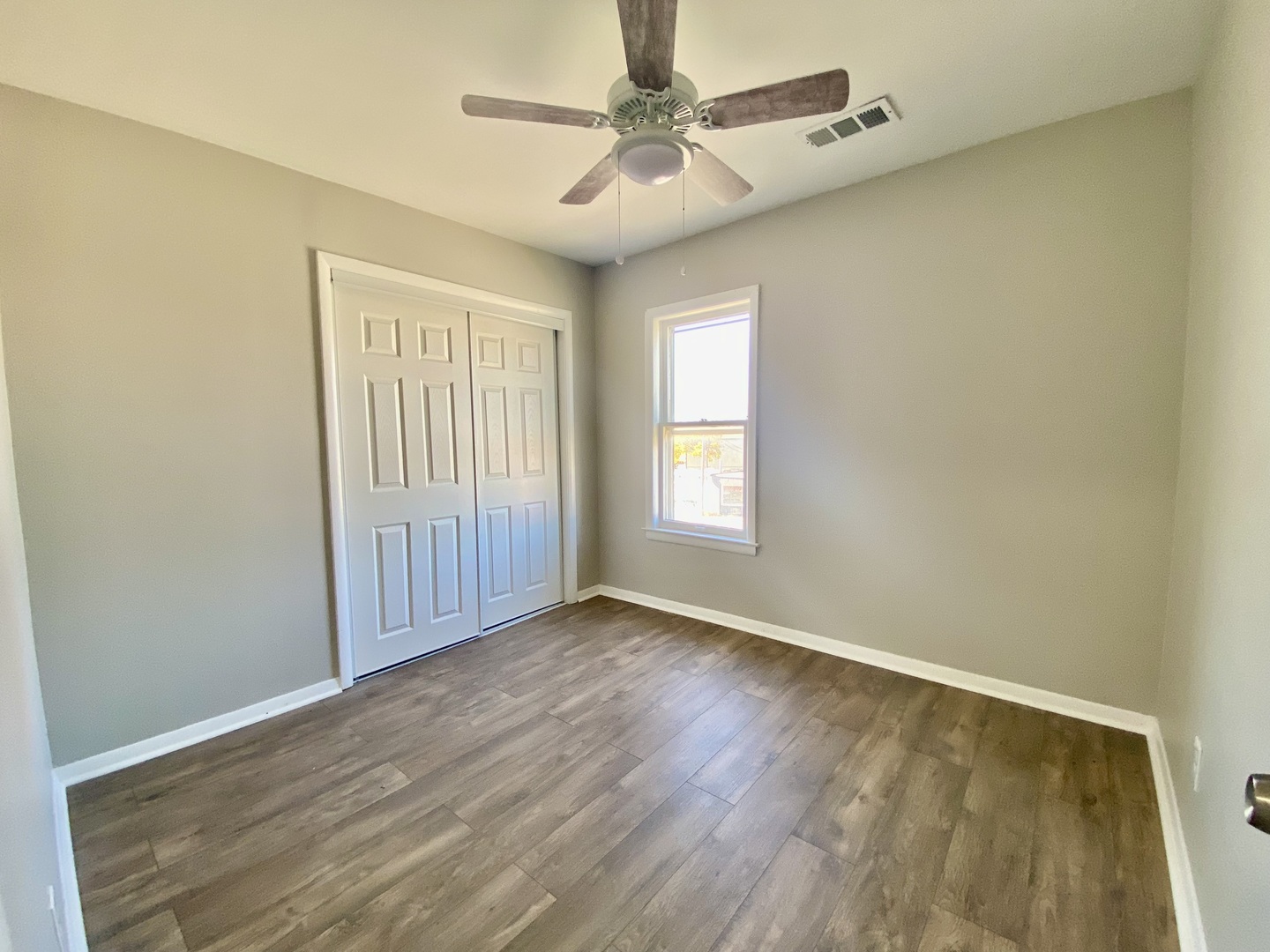 5543 West Margaret Street, Unit B Monee, IL 60449 - Photo 8 of 11 an empty room with windows and fan