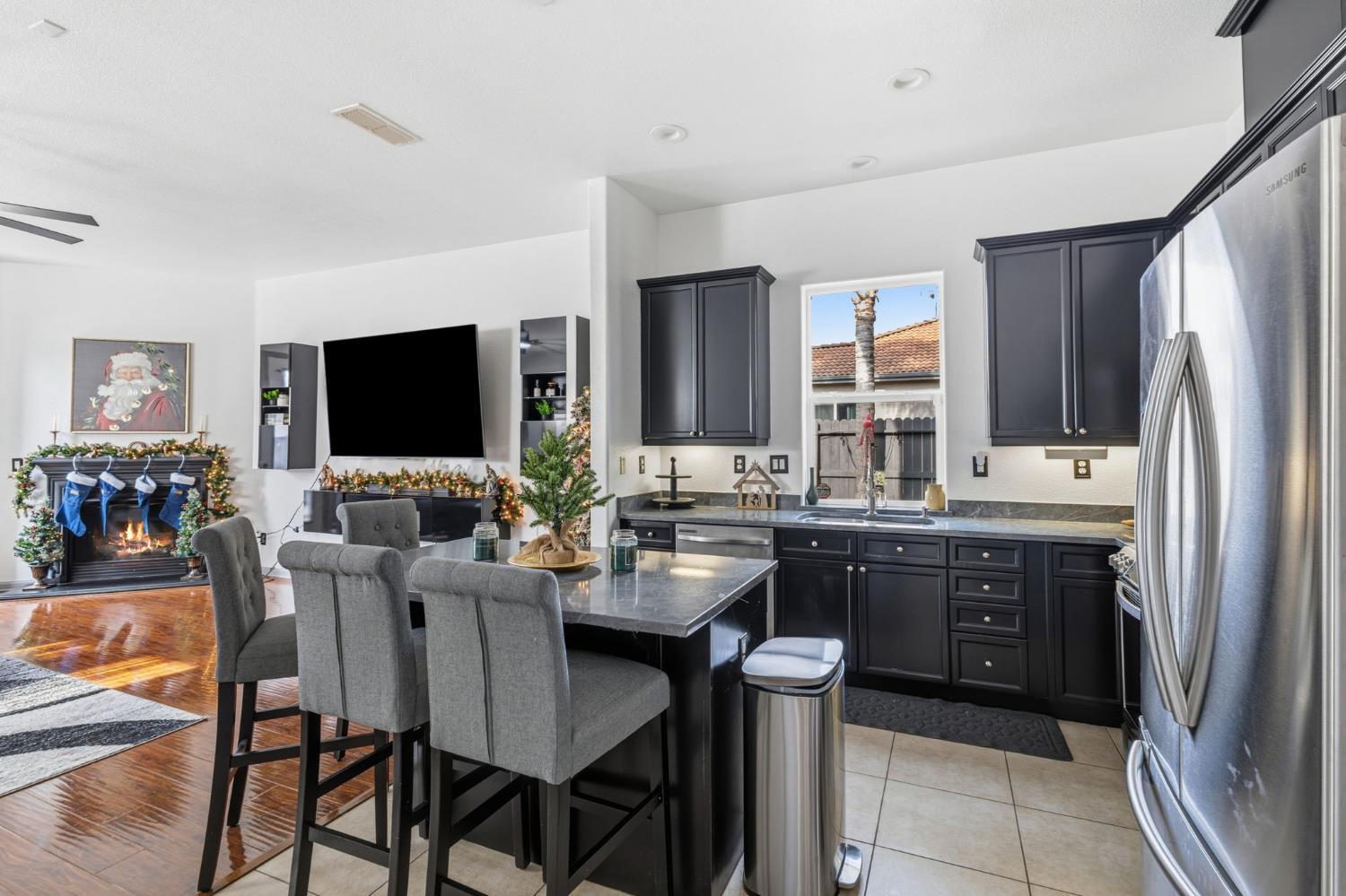 4215 Riopel Avenue Denair, CA 95316 - Photo 12 of 62 a kitchen with a table chairs refrigerator and microwave