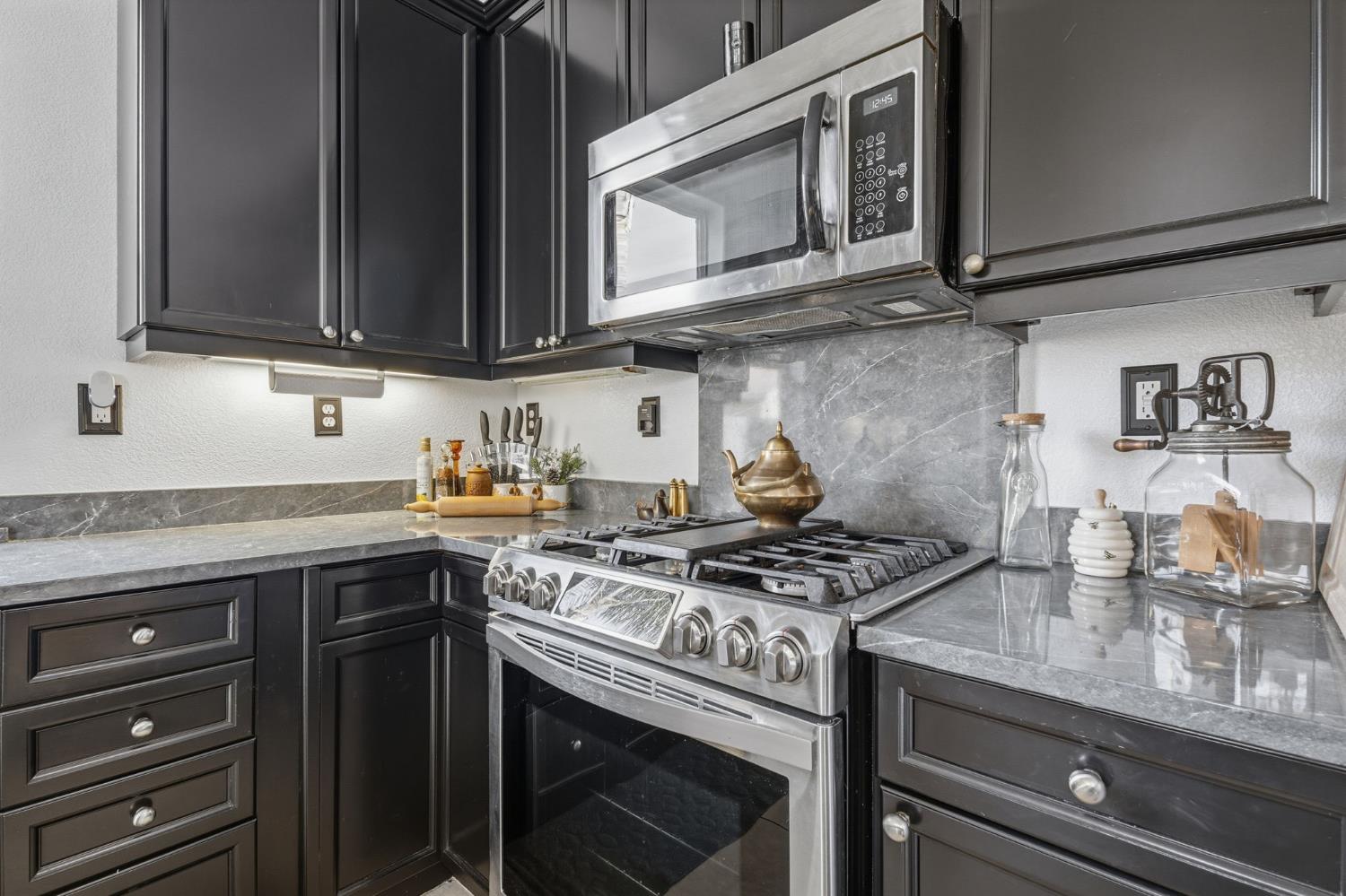 4215 Riopel Avenue Denair, CA 95316 - Photo 13 of 62 a kitchen with stainless steel appliances granite countertop a stove and a microwave