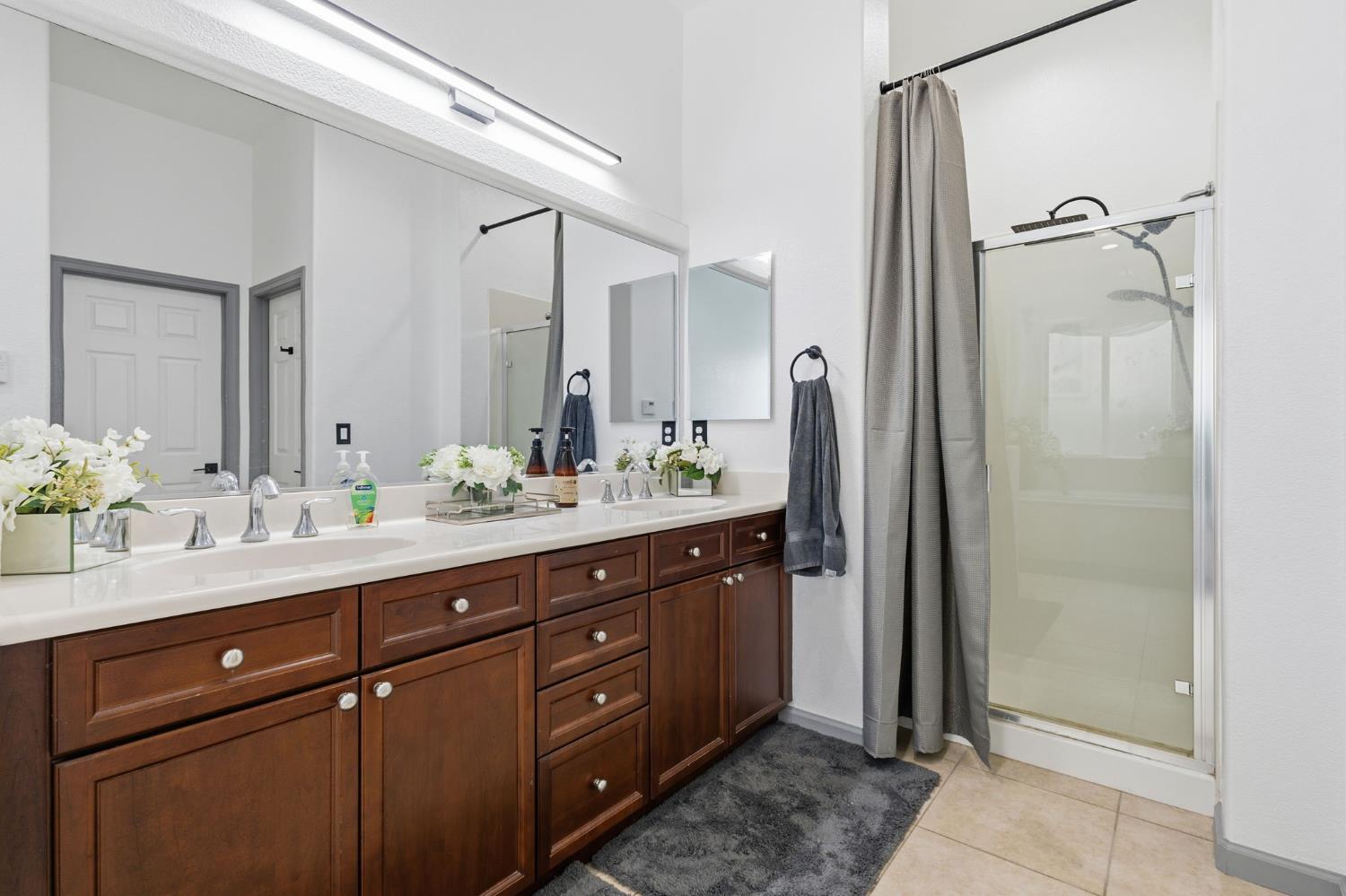 4215 Riopel Avenue Denair, CA 95316 - Photo 23 of 62 a spacious bathroom with a granite countertop sink mirror and double