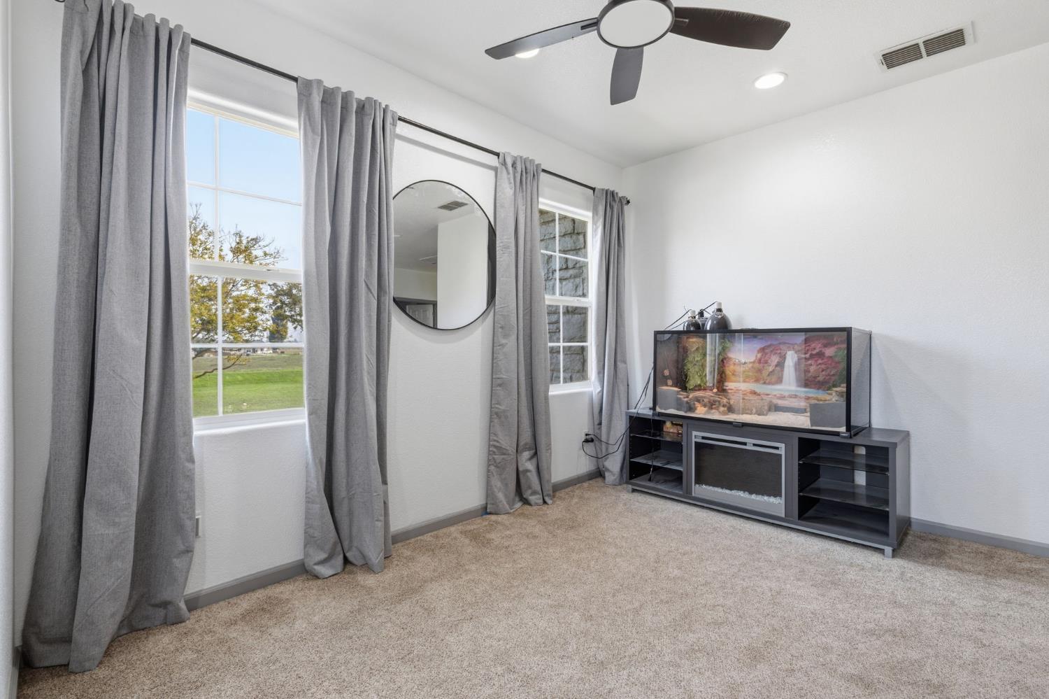 4215 Riopel Avenue Denair, CA 95316 - Photo 26 of 62 a livingroom with furniture a flat screen tv and kitchen view