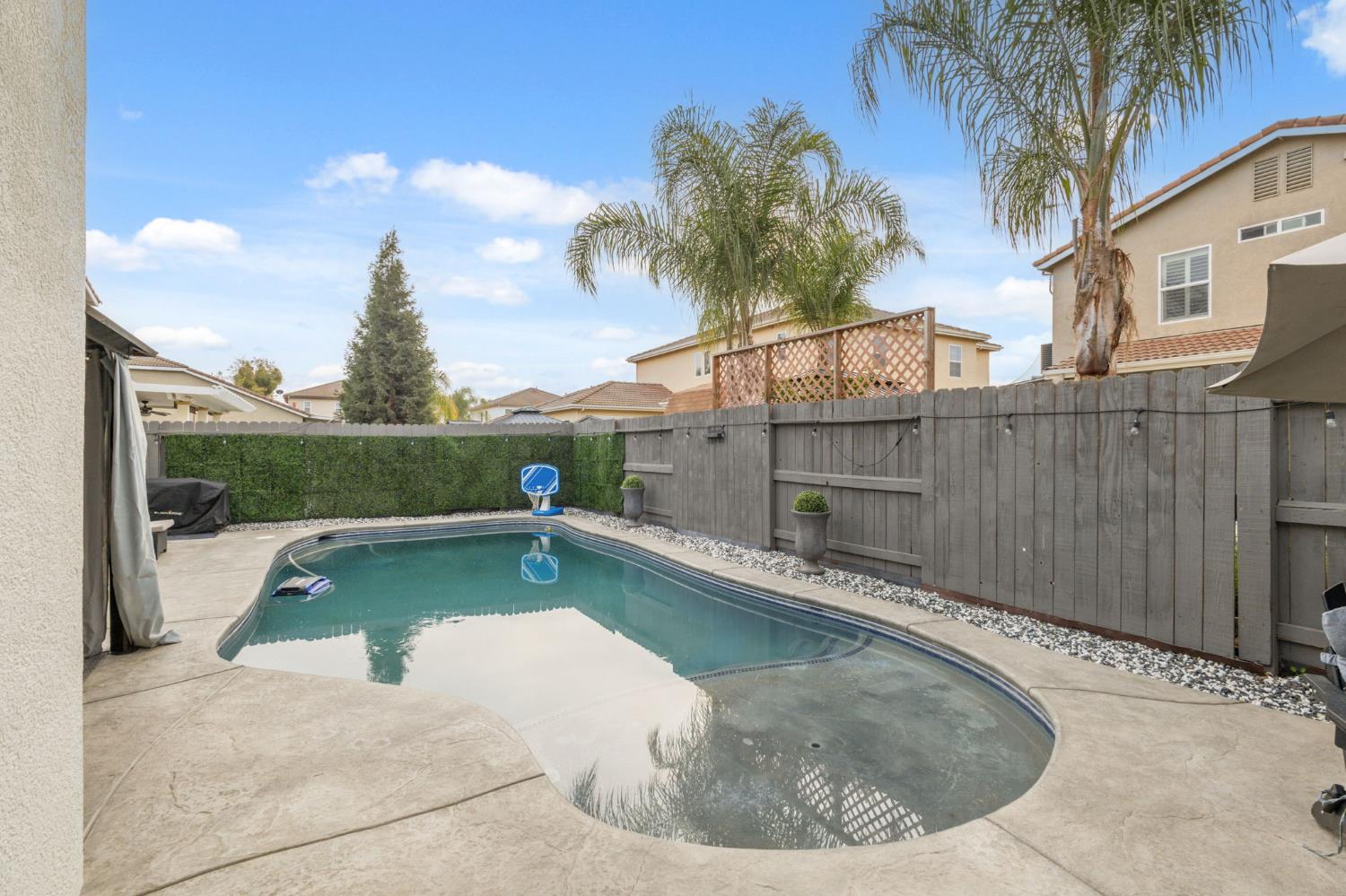 4215 Riopel Avenue Denair, CA 95316 - Photo 40 of 62 a view of a swimming pool with a porch