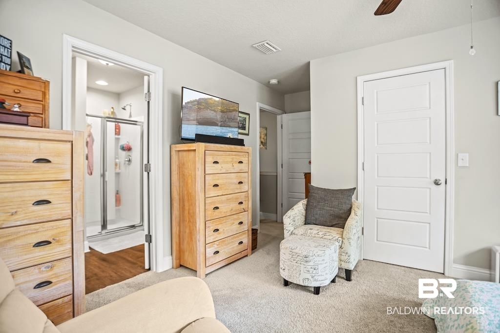 25806 Pollard Road, Unit 27 Daphne, AL 36526 - Photo 30 of 46 Bedroom featuring light colored carpet, ceiling fan, and ensuite bath