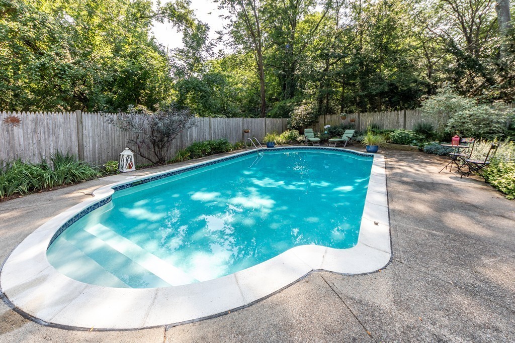 61 Volk Road Dedham, MA 02026 - Photo 14 of 26 a view of a swimming pool with a yard and trees