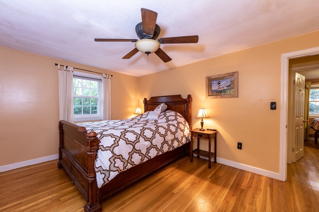 61 Volk Road Dedham, MA 02026 - Photo 18 of 26 a bedroom with a bed and wooden floor