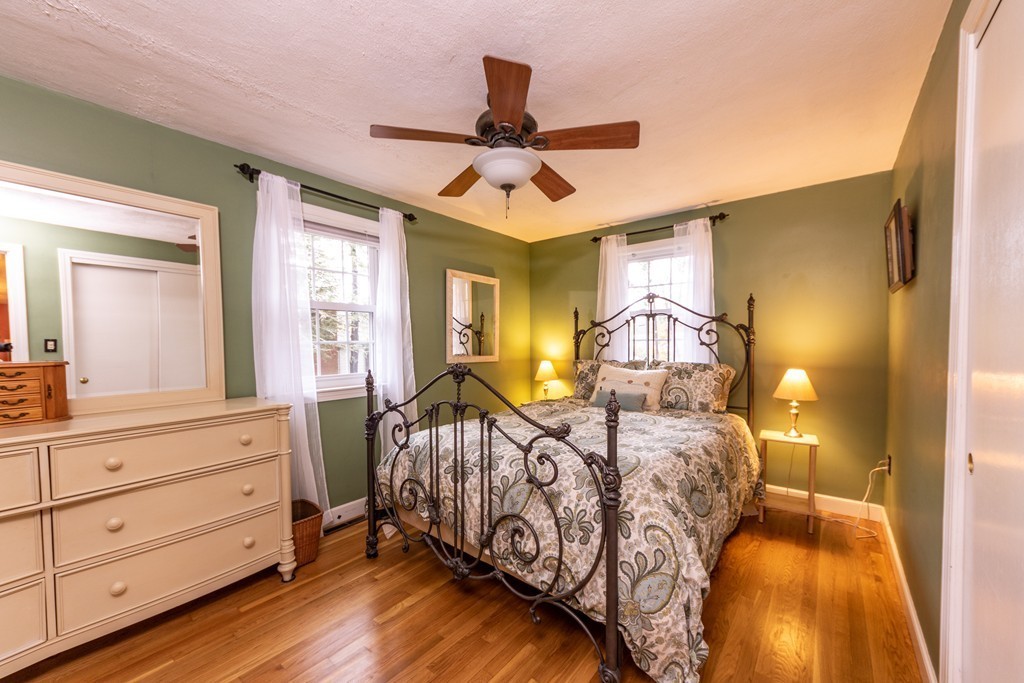 61 Volk Road Dedham, MA 02026 - Photo 19 of 26 a bedroom with a bed and wooden floor
