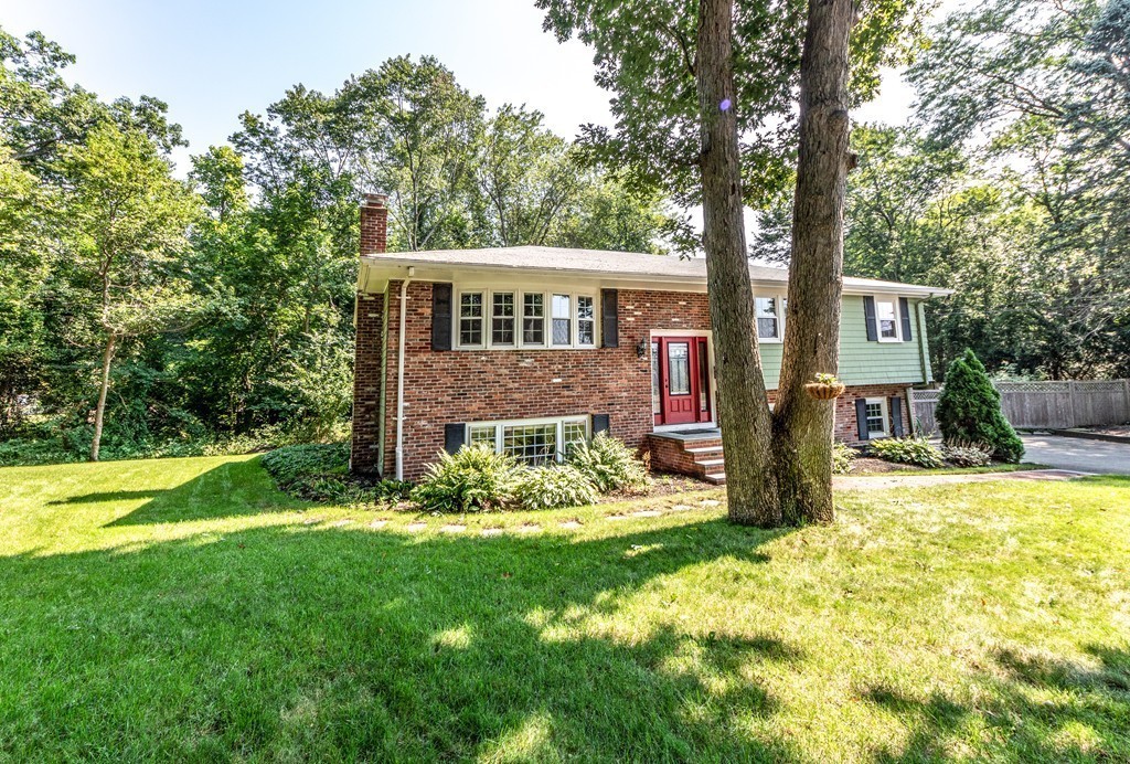61 Volk Road Dedham, MA 02026 - Photo 2 of 26 a front view of a house with a yard table and chairs