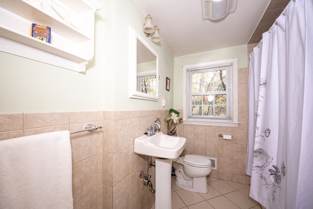 61 Volk Road Dedham, MA 02026 - Photo 21 of 26 a bathroom with a sink toilet and shower
