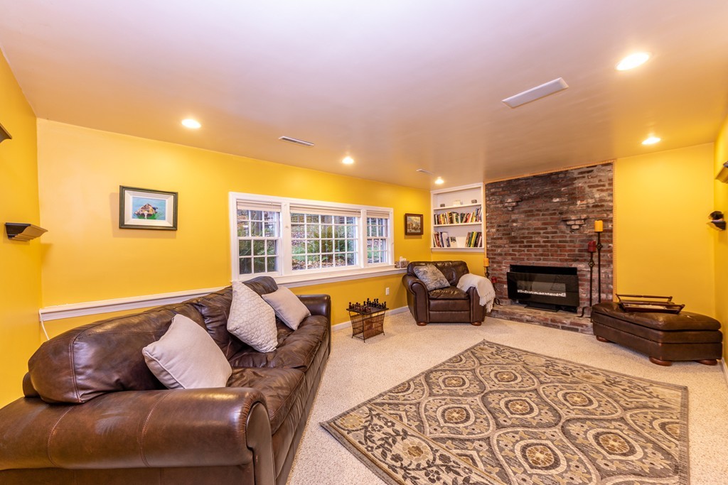 61 Volk Road Dedham, MA 02026 - Photo 22 of 26 a bedroom with furniture and a fireplace