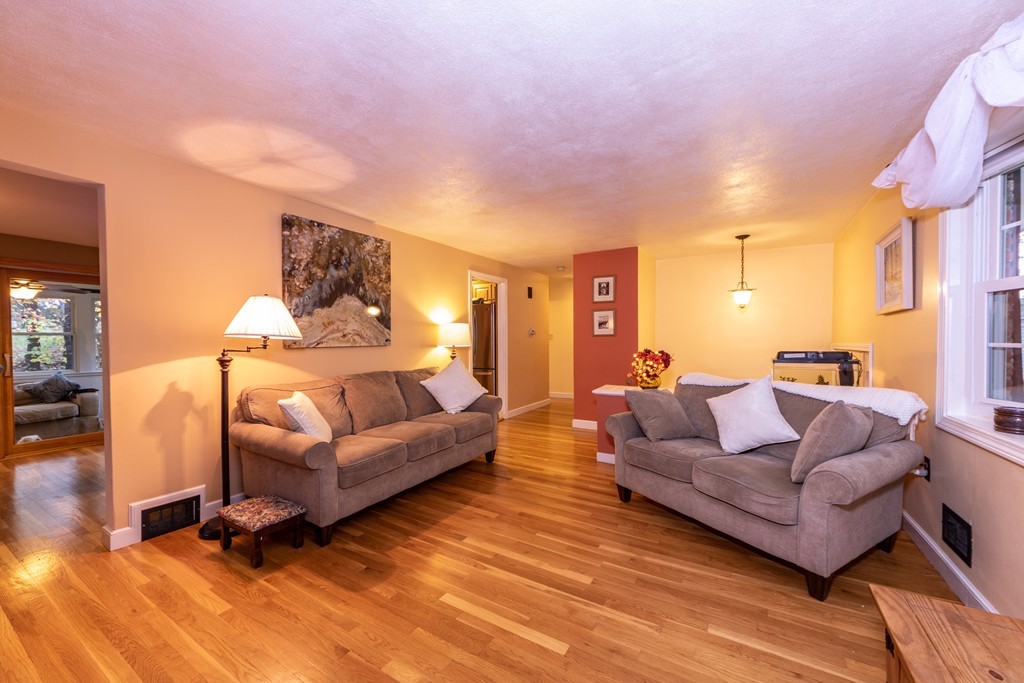 61 Volk Road Dedham, MA 02026 - Photo 4 of 26 a living room with furniture and a wooden floor