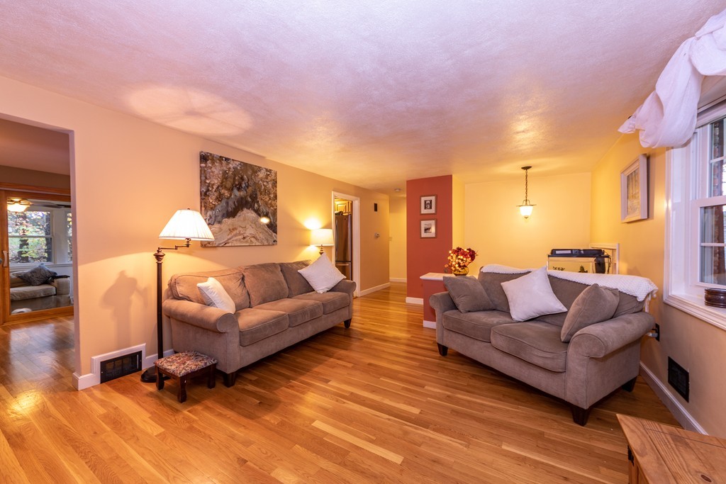 61 Volk Road Dedham, MA 02026 - Photo 5 of 26 a living room with furniture and a wooden floor