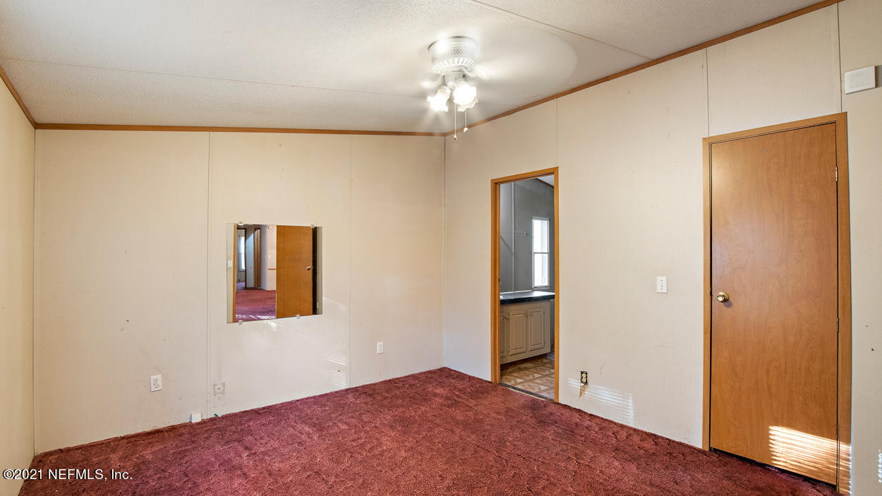5751 Benedict Road Jacksonville, FL 32209 - Photo 5 of 11 a view of empty room with wooden floor and fan