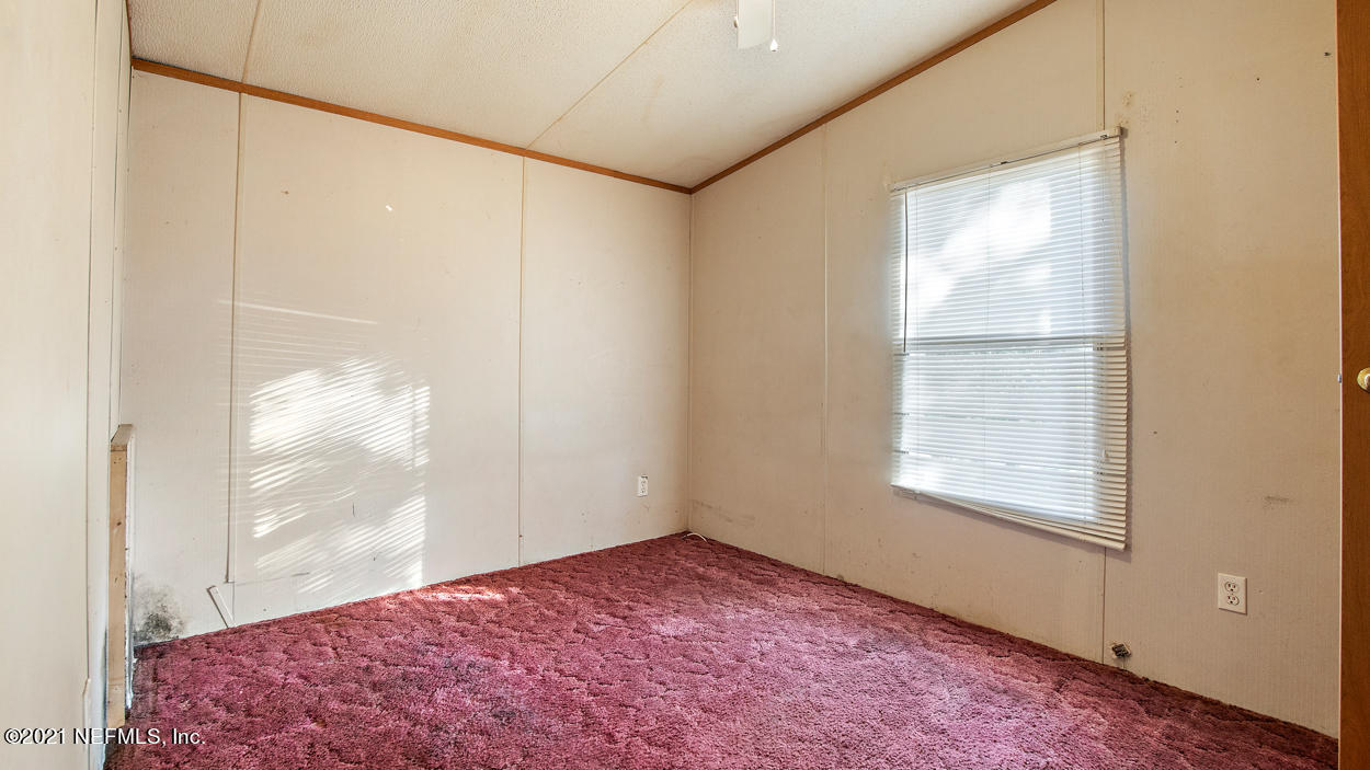5751 Benedict Road Jacksonville, FL 32209 - Photo 9 of 11 an empty room with windows