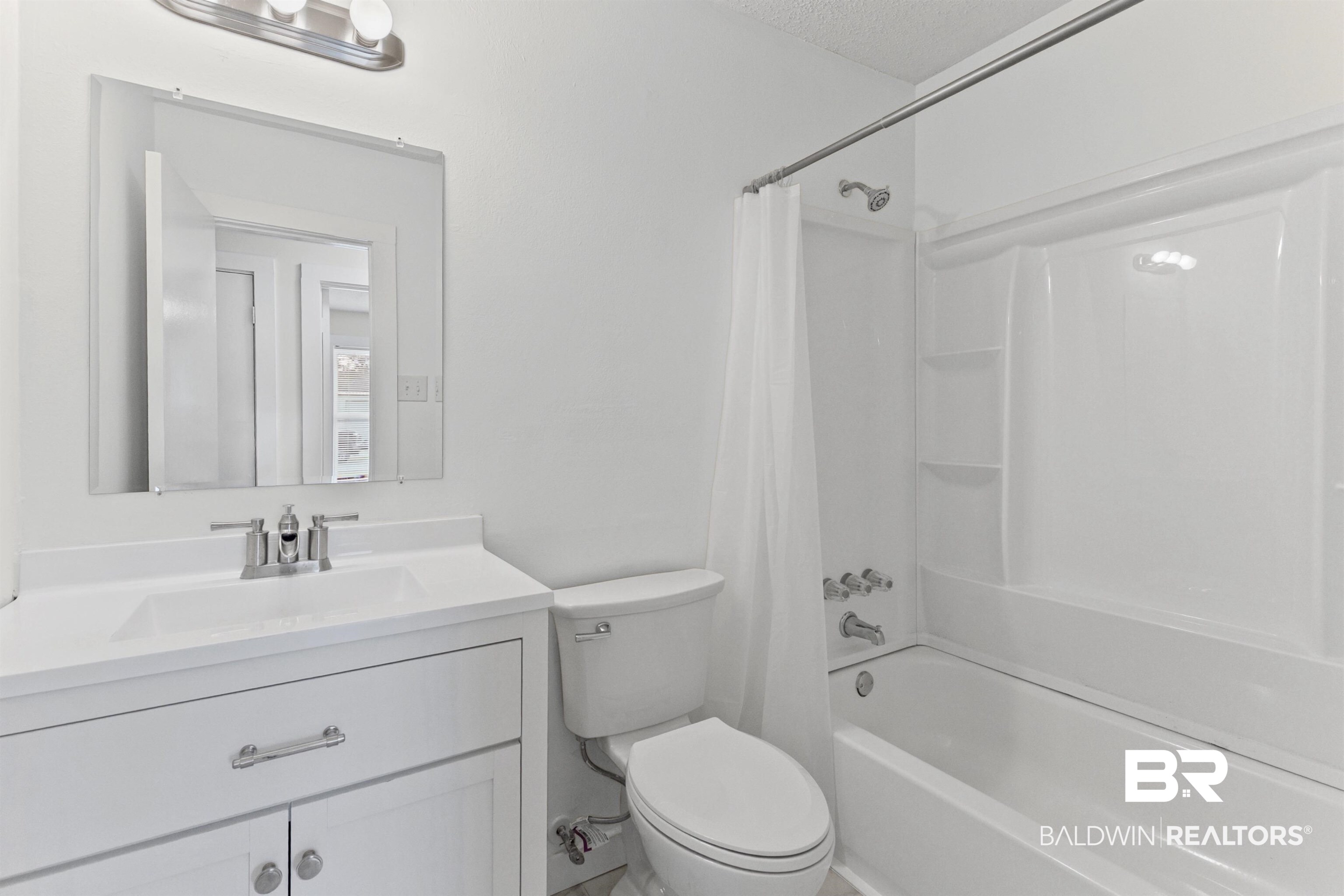 7795 Bellingrath Road Theodore, AL 36582 - Photo 12 of 18 Bathroom with shower / bath combination with curtain, vanity, and a textured ceiling