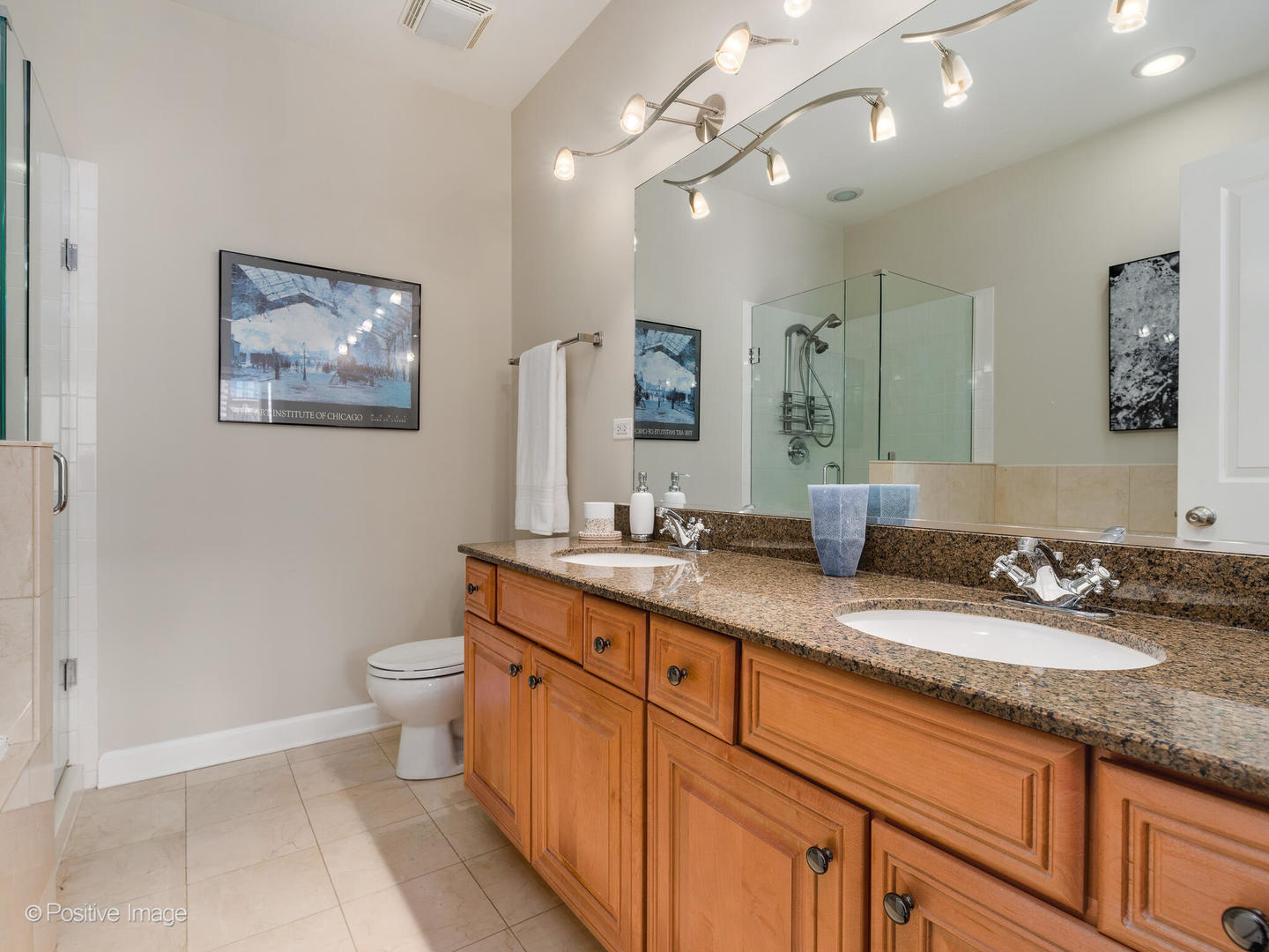 1704 South Morgan Street, Unit 2 Chicago, IL 60608 - Photo 14 of 18 a bathroom with a granite countertop double vanity sink a mirror and a toilet