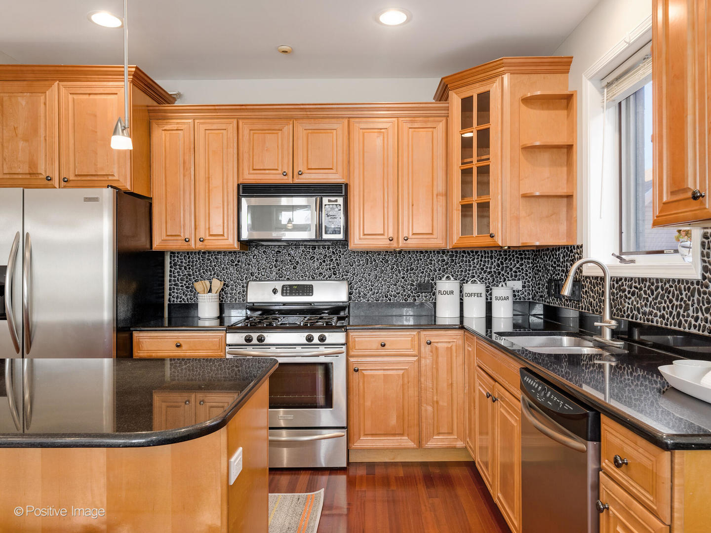 1704 South Morgan Street, Unit 2 Chicago, IL 60608 - Photo 3 of 18 a kitchen with stainless steel appliances granite countertop a stove a sink and a microwave