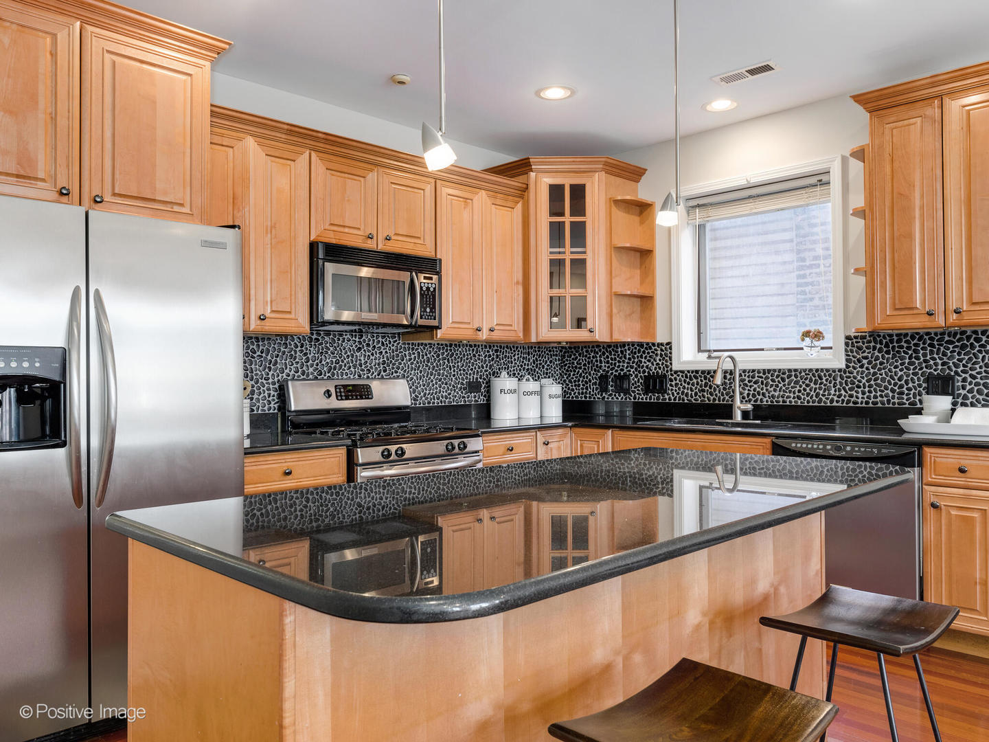 1704 South Morgan Street, Unit 2 Chicago, IL 60608 - Photo 4 of 18 a kitchen with stainless steel appliances granite countertop a sink a stove and a refrigerator