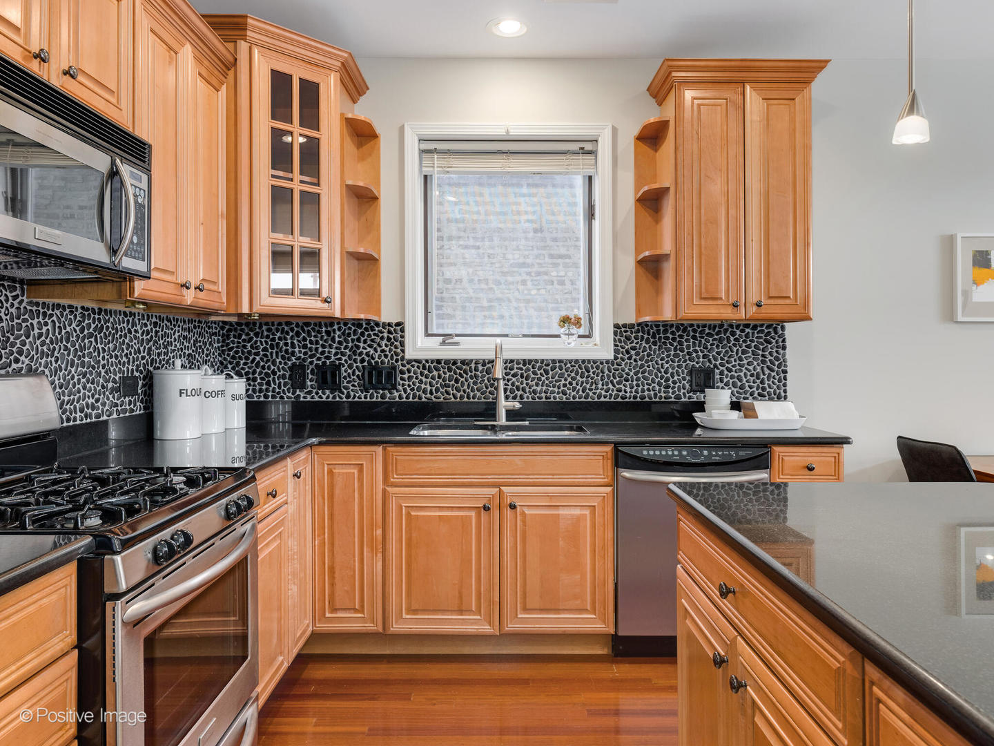 1704 South Morgan Street, Unit 2 Chicago, IL 60608 - Photo 5 of 18 a kitchen with stainless steel appliances granite countertop a sink stove and cabinets