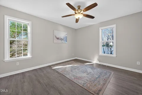 a bedroom with a bed couch and window