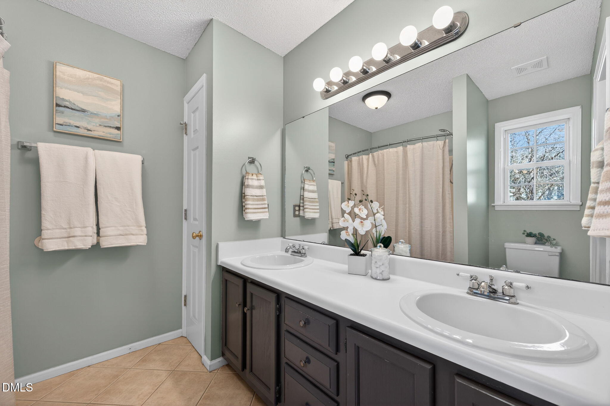11 Hemlock Court Angier, NC 27501 - Photo 25 of 48 a bathroom with double vanity sinks a vanity a lamp and a mirror