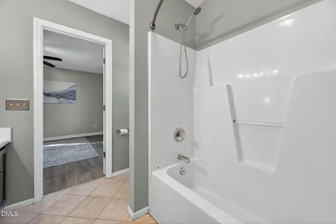 a bathroom with double vanity sinks a vanity a lamp and a mirror