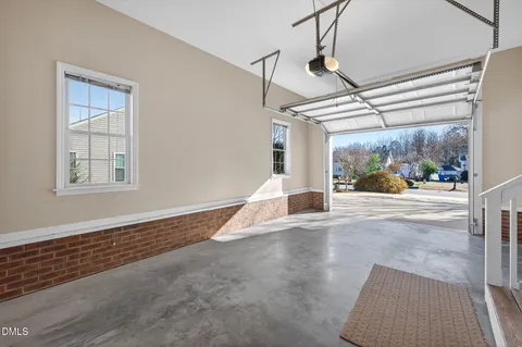 a view of a room with wooden floor and window
