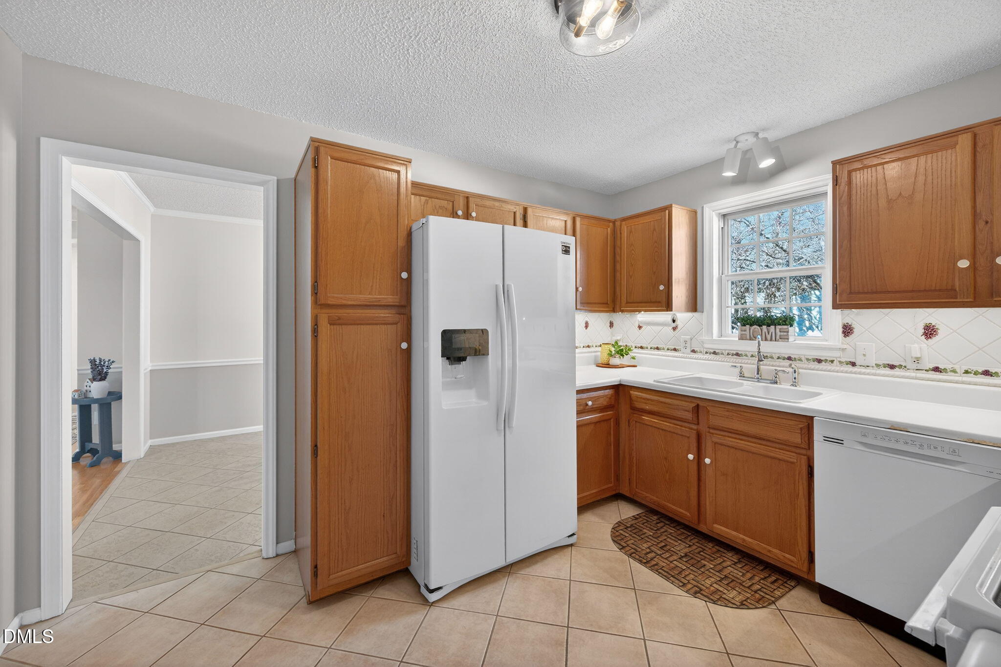 11 Hemlock Court Angier, NC 27501 - Photo 5 of 48 a kitchen with granite countertop a refrigerator and a sink