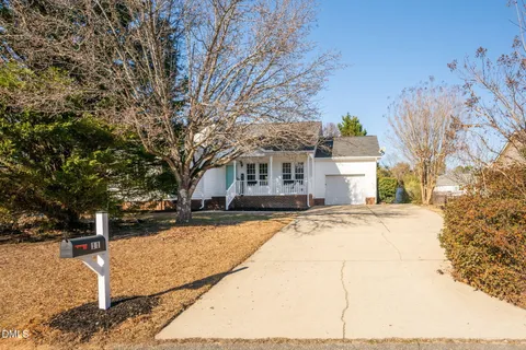 a view of a house with snow on the road