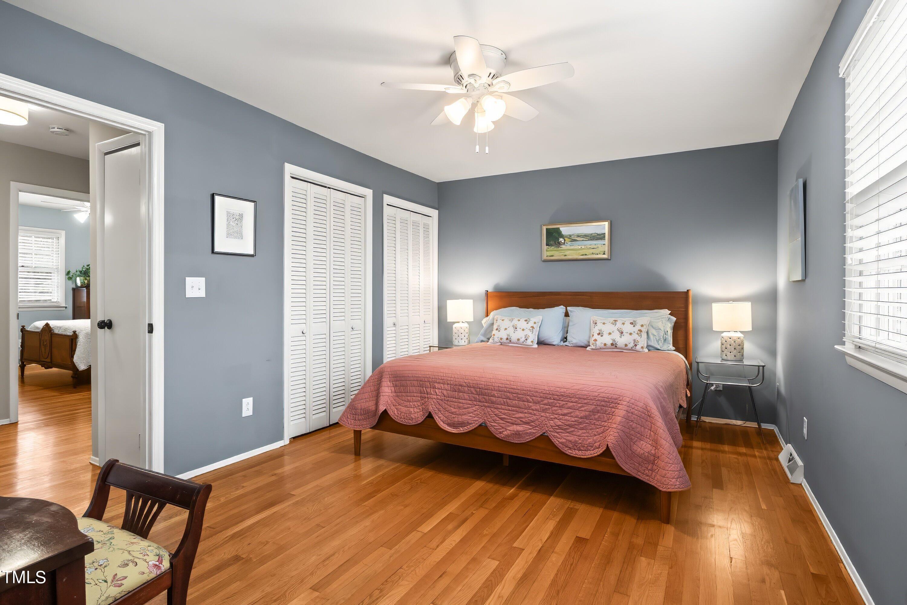 528 Harvard Street Raleigh, NC 27609 - Photo 14 of 44 a bedroom with a bed and a chandelier