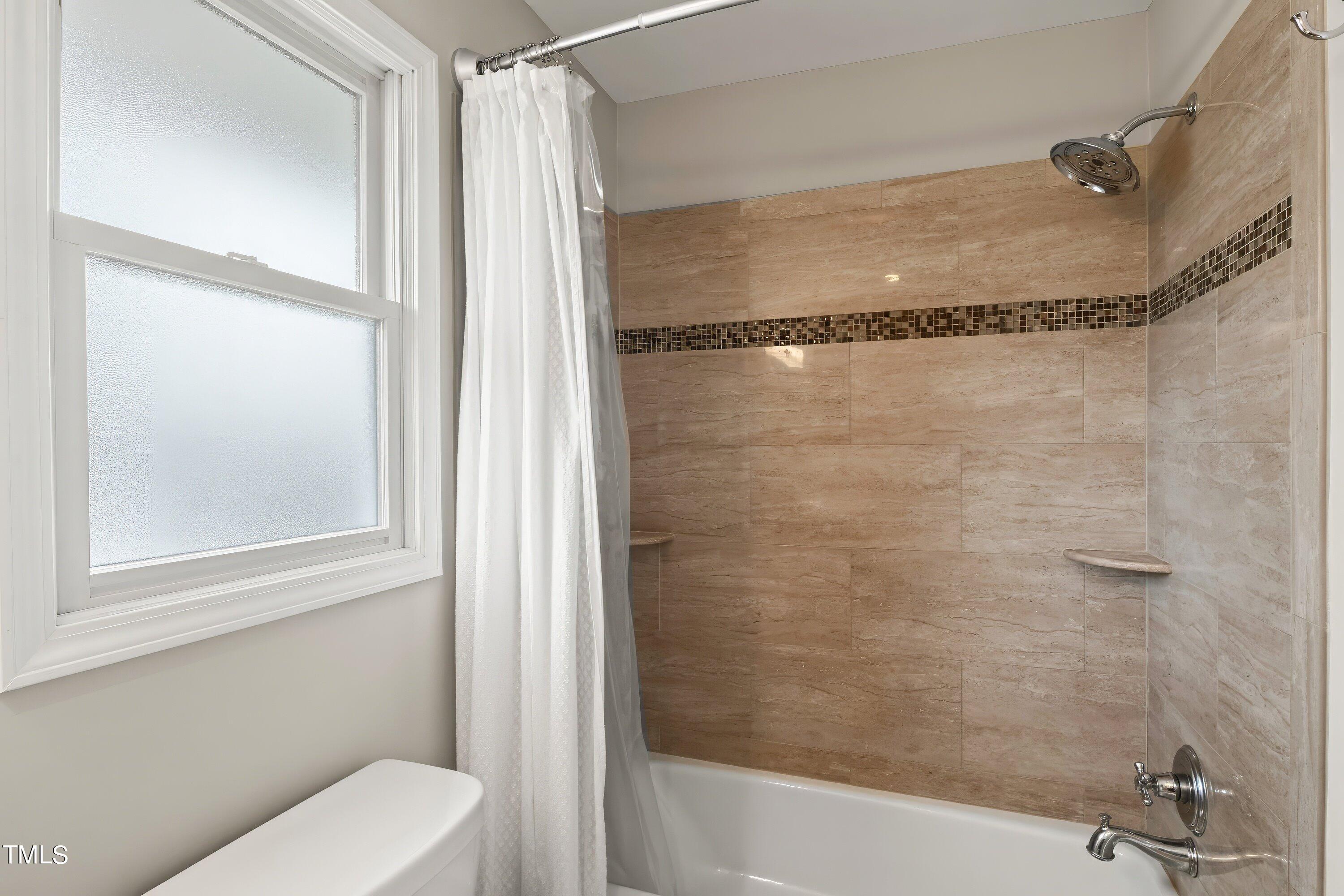 528 Harvard Street Raleigh, NC 27609 - Photo 16 of 44 a bathroom with a shower and a toilet