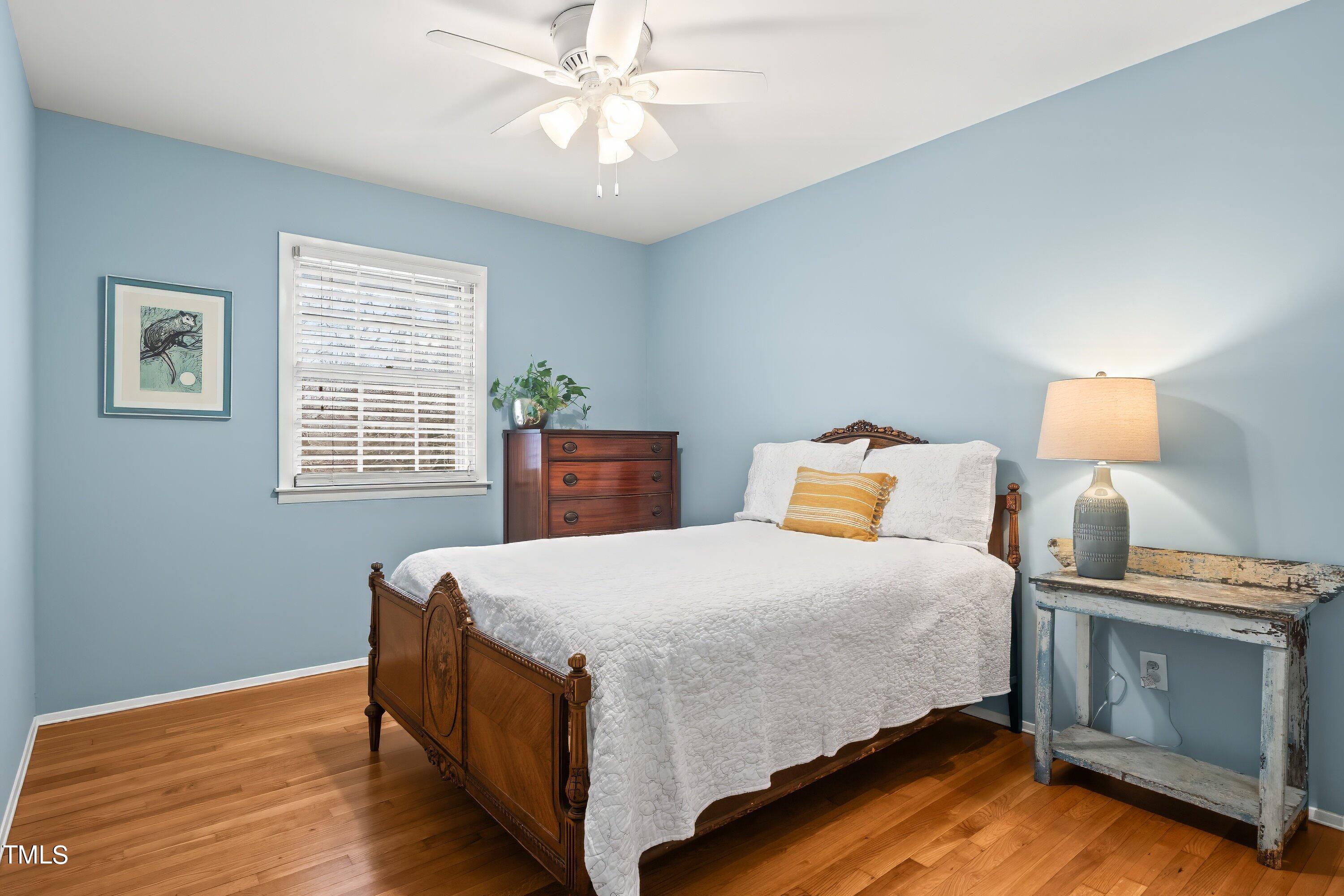 528 Harvard Street Raleigh, NC 27609 - Photo 17 of 44 a bedroom with a bed and a lamp on dresser