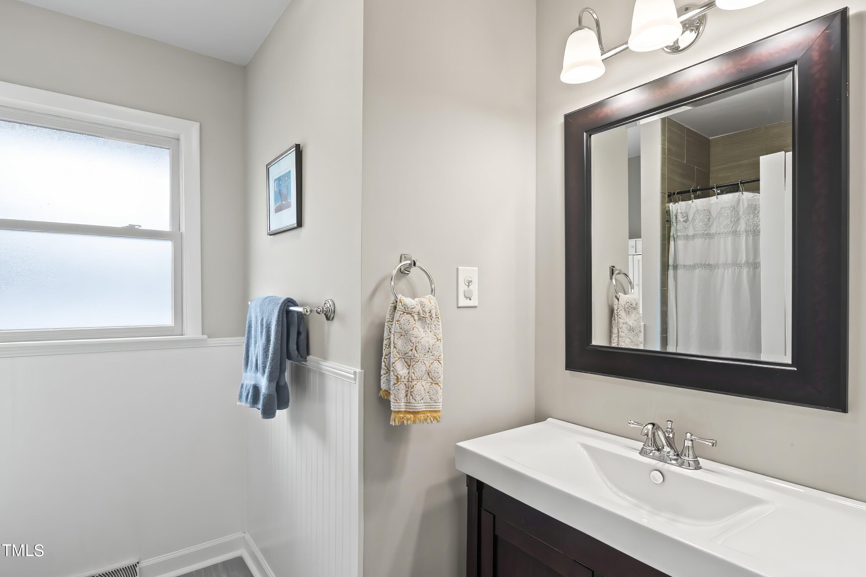 528 Harvard Street Raleigh, NC 27609 - Photo 19 of 44 a bathroom with a sink and a mirror