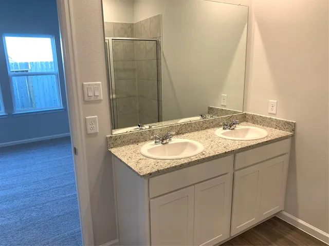 a bathroom with a glass shower door