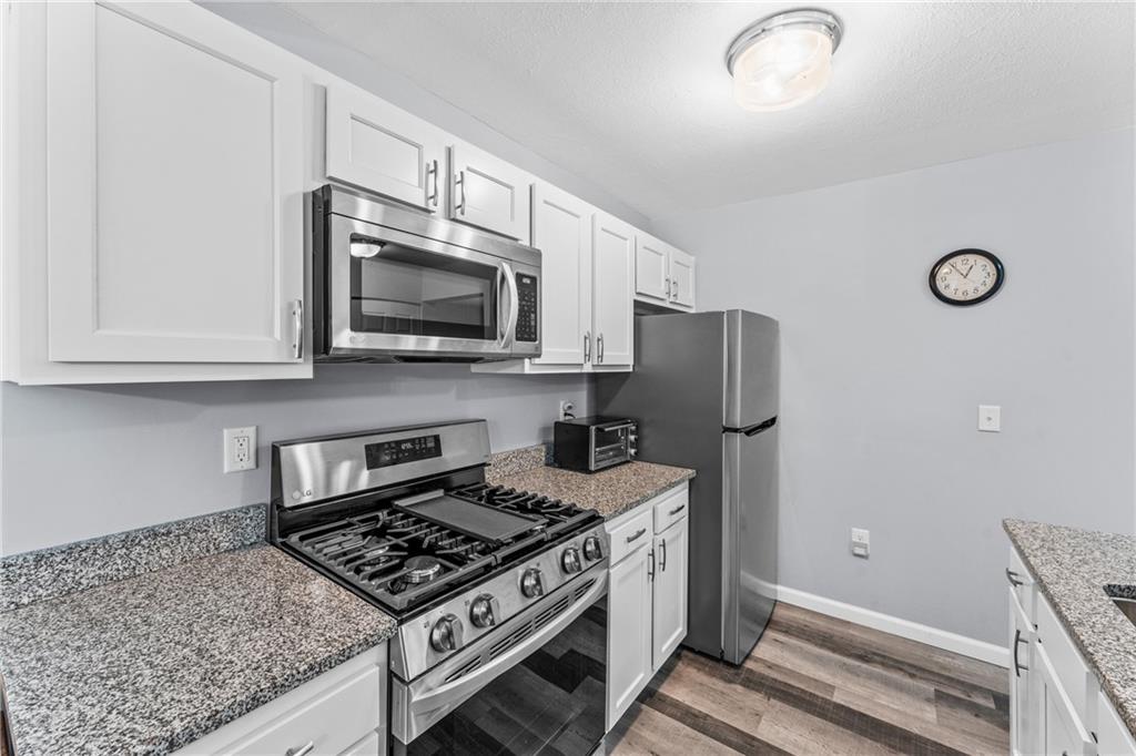 332 Central Drive Cranberry Township, PA 16066 - Photo 5 of 28 a kitchen with stainless steel appliances granite countertop a stove and a microwave