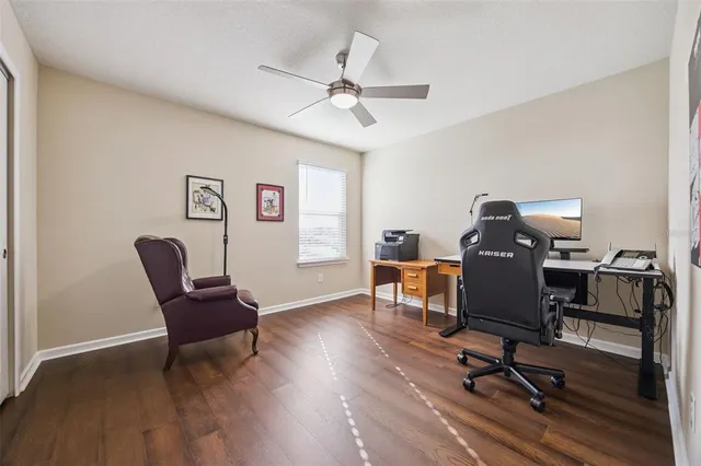 a view of a workspace with furniture and a window
