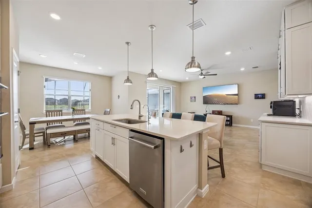 a kitchen with stainless steel appliances granite countertop a sink and a refrigerator