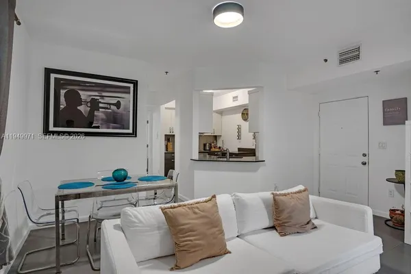 a bedroom with a bed and painting on the wall