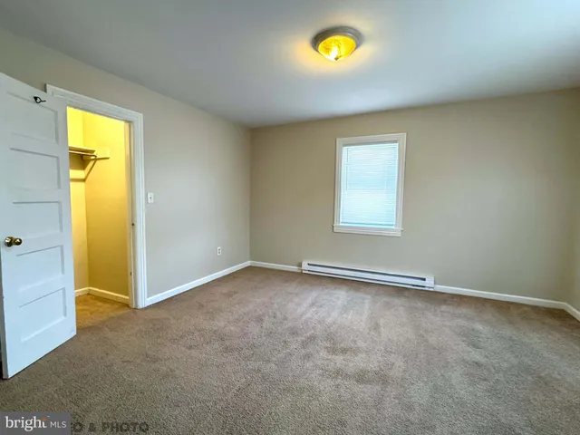 an empty room with a window and painted walls