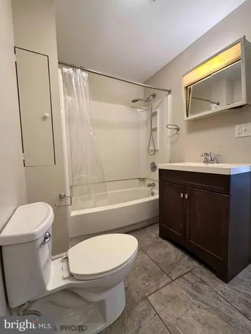 a bathroom with a toilet a sink and bathtub