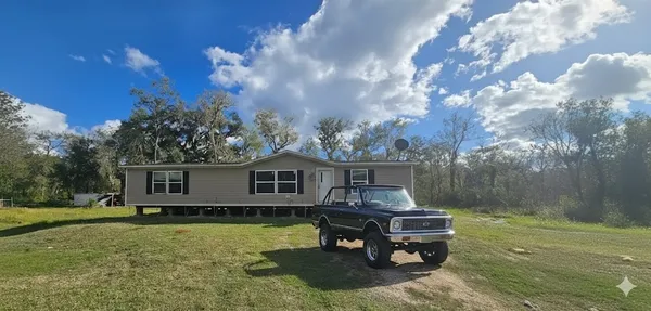 a small pool with a yard in the back